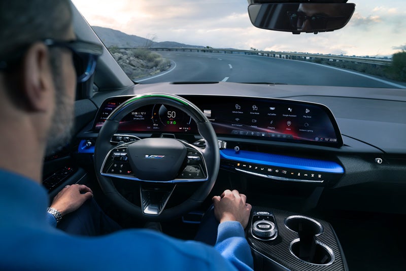 Front View of the 2026 OPTIQ-V Driving Through the Dusk Utilizing its Headlights | Bachman-Bernard Cadillac in GREENEVILLE TN